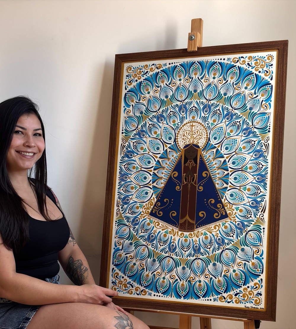 Thays Oliveira, artista da Japa Mandalas, ao lado de sua mandala de Nossa Senhora Aparecida pintada à mão